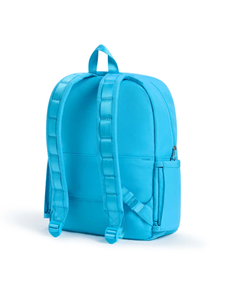 A kane double pocket backpack in bright blue by state bags, featuring adjustable padded straps, a top carrying handle, and a side pocket, is shown from the back against a white background.