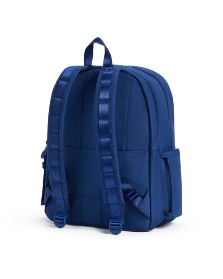 A STATE Bags Kane Double Pocket Backpack in navy, shown from the back, featuring adjustable padded straps, a top handle, and side pockets. The backpack has a plain design with no visible logos or embellishments.