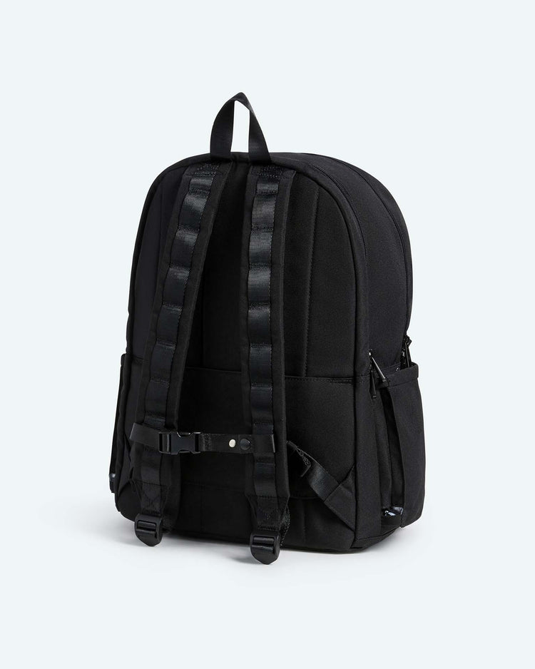 The Reed Backpack in Black by STATE Bags is displayed from the back, highlighting its padded shoulder straps, adjustment buckles, carrying handle, and side pockets. Its simple and functional design makes it an excellent choice for a school backpack.