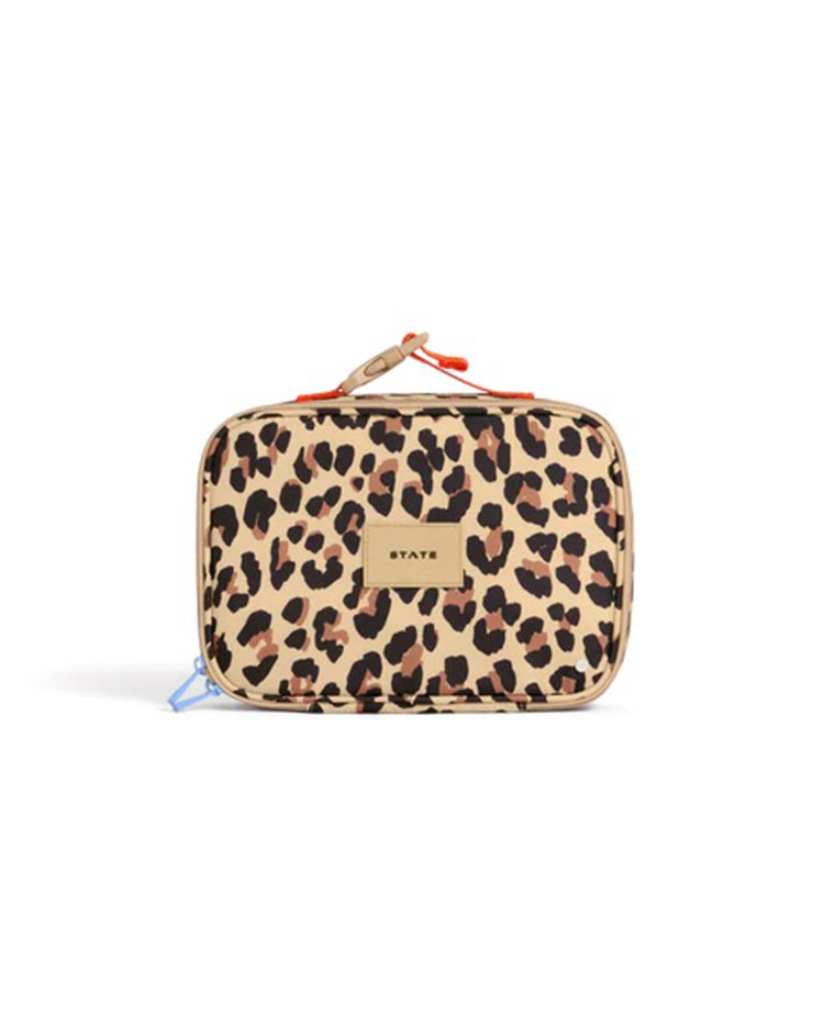 The Rodgers Lunch Box in Leopard from STATE Bags is a rectangular insulated lunch box featuring a brown, black, and tan leopard print pattern, a beige label with "STATE" in the center, and a red strap on top for added style.