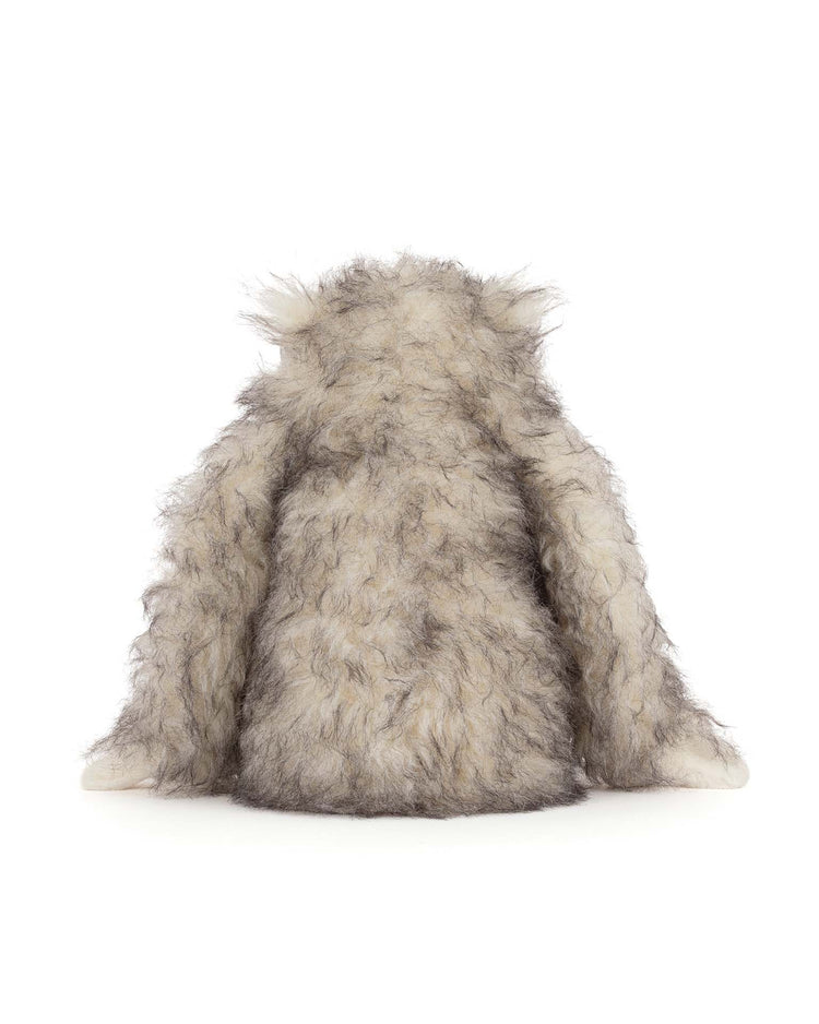 The jellycat bretti yeti is a fuzzy gray and white plush with long arms and no visible face or legs, shown against a plain white background.
