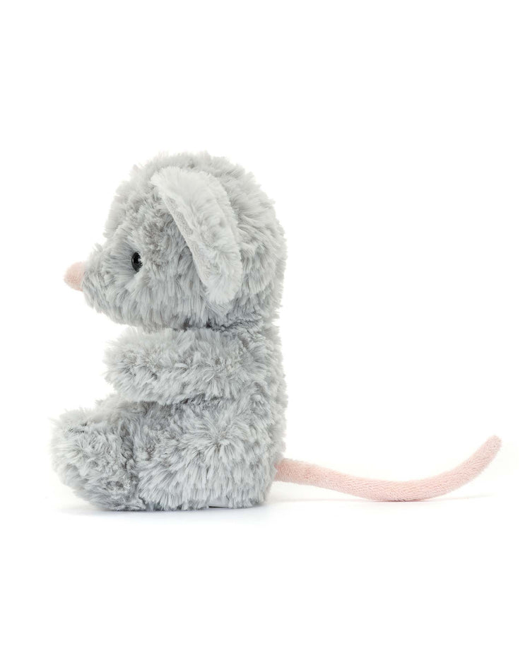 The Yummy Mouse by Jellycat is a fluffy gray stuffed animal with a long pink tail and nose, sitting upright and facing left against a plain white background. Its the ideal cuddling toy and makes a charming gift for kids.