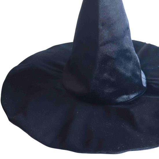 The Spellbound Witch Costume Set in Black by Bailey and Ava includes a black velvet witch hat featuring a tall, pointed crown and wide brim, perfect for completing any witch ensemble.