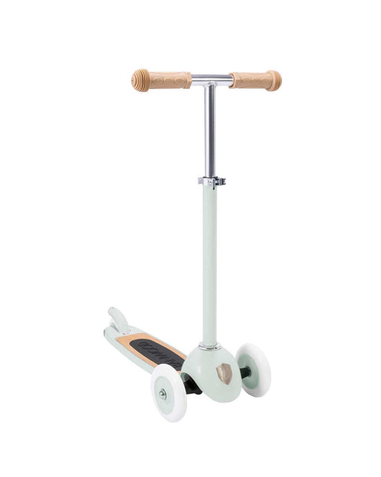 The banwood scooter in mint by banwood is a retro three-wheel kick scooter for children with a light green frame, tan handlebars, white wheels, black footboard, and Easy Ride Steering System for smooth control.