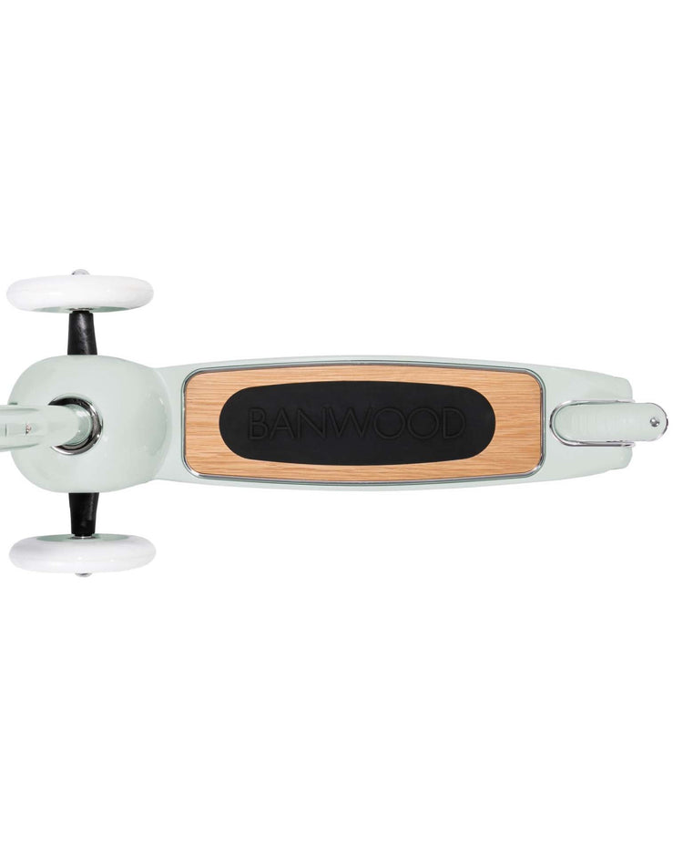 Top view of the banwood scooter in mint featuring white wheels, a light green frame, a wooden deck with banwood branding, and an Easy Ride Steering System.