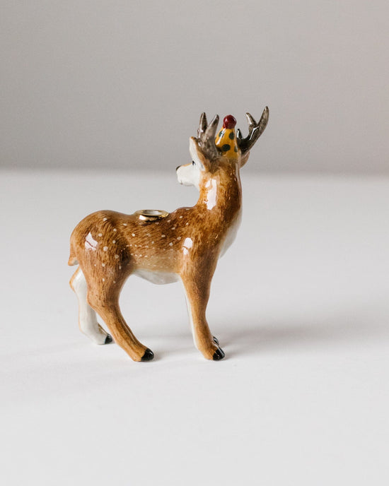 Small ceramic figurine of a brown deer with a bird perched on its antlers, set against a plain white background, showcasing heirloom-quality craftsmanship.
Product Name: stag cake topper
Brand Name: Camp Hollow