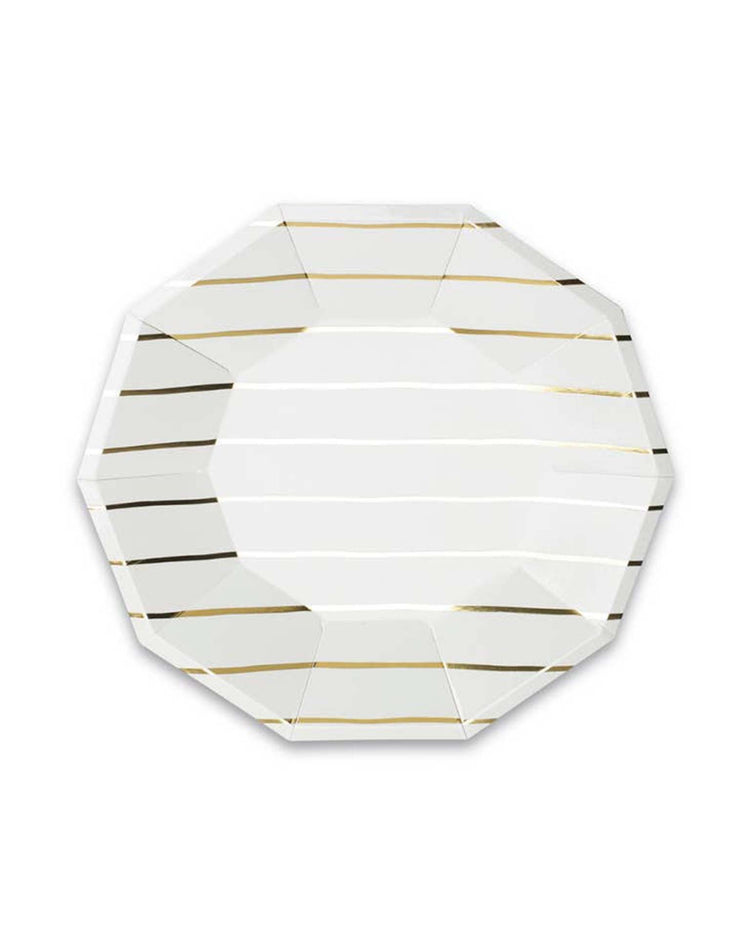 The gold Frenchie striped small plate from Daydream Society is an octagonal white plate adorned with gold and black horizontal stripes, reminiscent of the classic French Breton stripe, displayed on a white background.