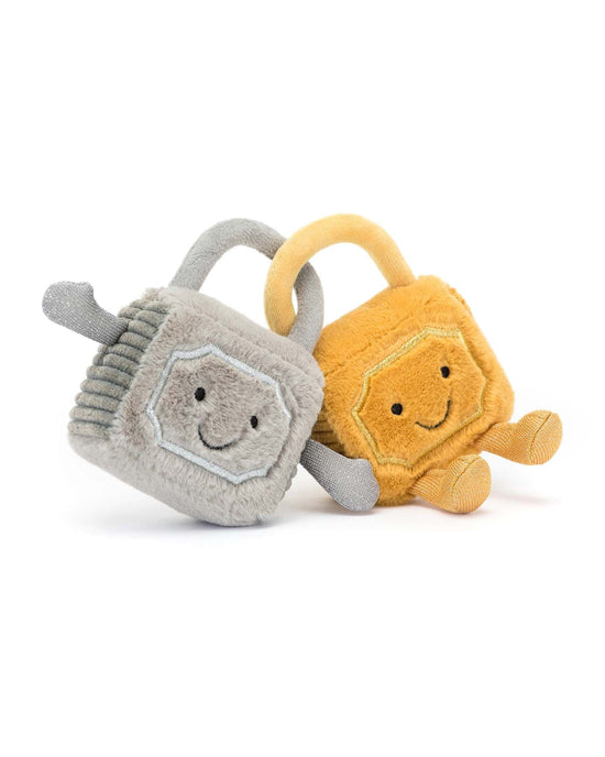 Two Amuseable Love Locks from Jellycat, one in gray and the other in yellow, both featuring embroidered smiling faces and arms, positioned against a white background. This adorable pair of stuffed animals is sure to brighten anyone’s day.