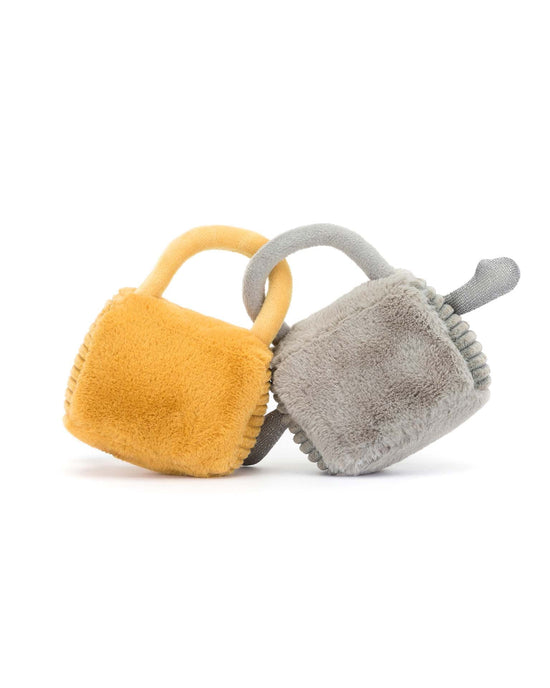 Two plush square toys with handles, one yellow and one gray, are intertwined against a white background—an adorable representation of Jellycat's Amuseable Love Locks for any cute couple to enjoy.