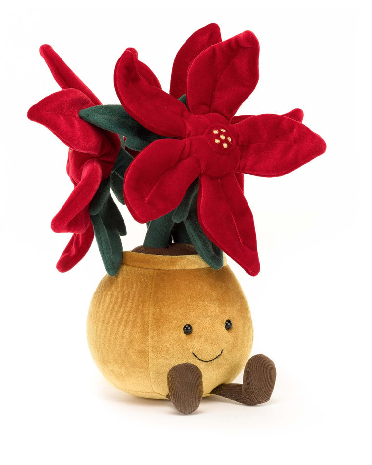 The Jellycat Amuseable Poinsettia is a plush toy resembling a smiling, stylish plant with red petals and green leaves, perfect as a holiday companion or gift.
