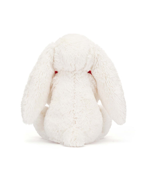Back view of a super soft, white plush stuffed bunny from Jellycat's Bashful Red Love Heart Bunny Little collection, featuring long floppy ears and a bashful red love heart on its chest.