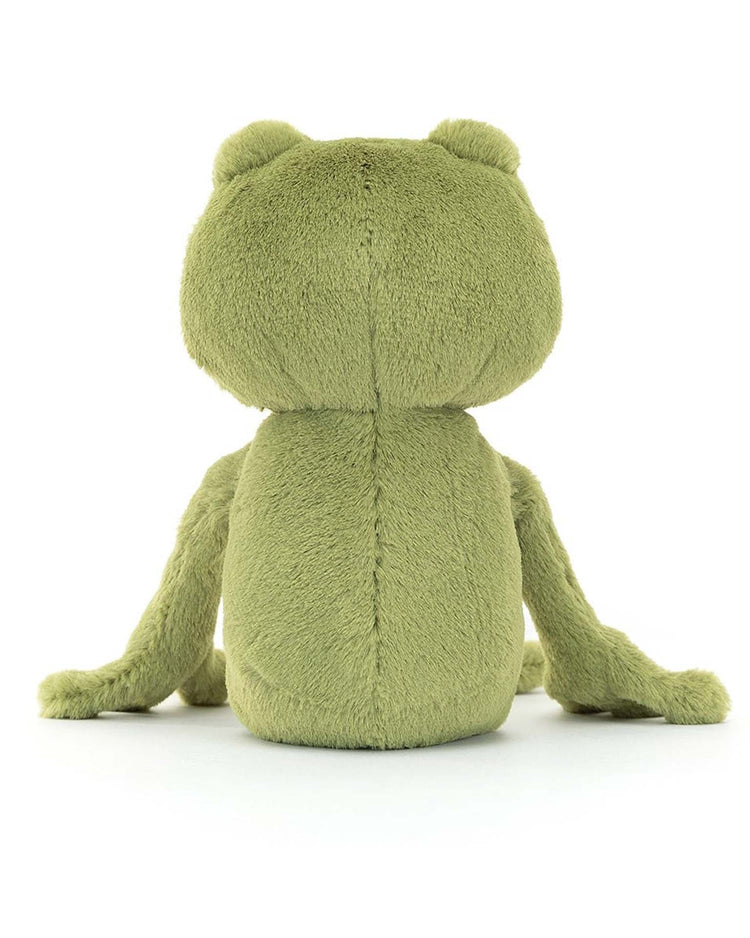 A plush toy frog, named Finnegan Frog from Jellycat, is seated with its back facing the viewer. The stuffed animal features a soft, fuzzy-looking texture and a delightful mossy green fur.
