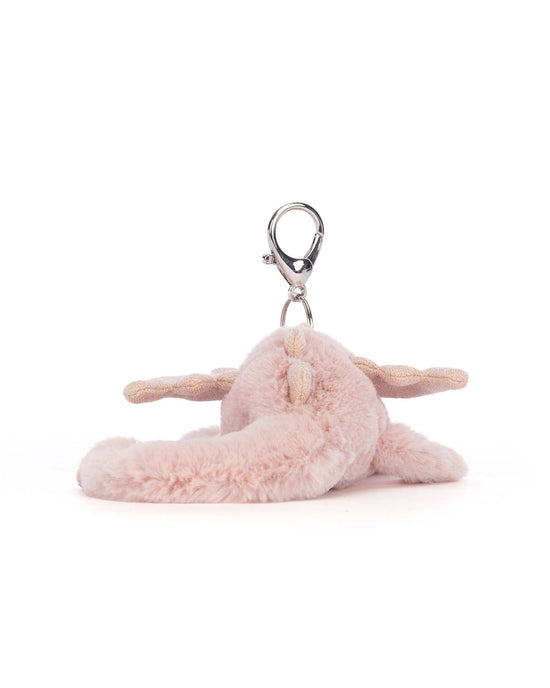 Jellycat's rose dragon bag charm features a plush pink design with floppy ears, glittery wings, and a metal clasp attachment, making it perfect as a charming accessory for your bag.