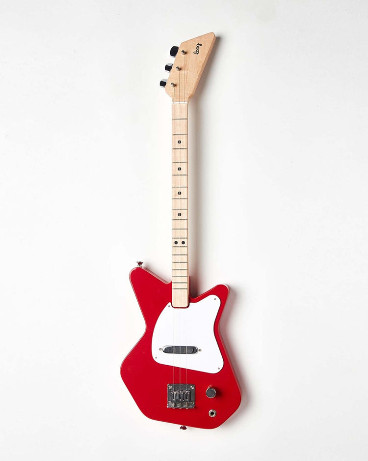 The Loog Pro Electric in Red from Loog Guitars, featuring a uniquely shaped body, white pickguard, and light-colored neck and headstock, is positioned against a plain white backdrop, making it perfect for beginners.