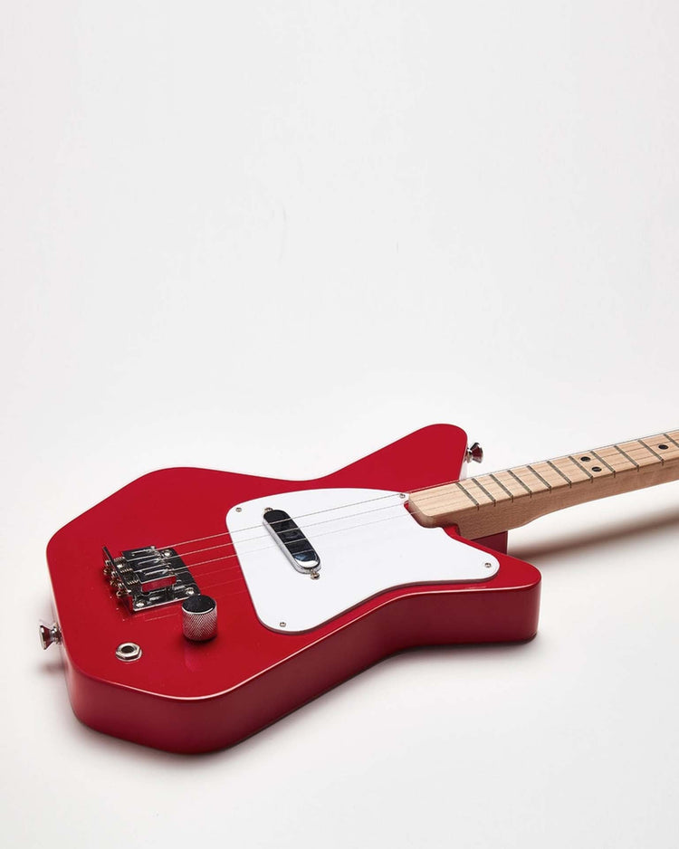 A Loog Pro Electric guitar in red, crafted by Loog Guitars, featuring a white pickguard, single pickup, and a maple neck is photographed against a plain white background—ideal for beginners.