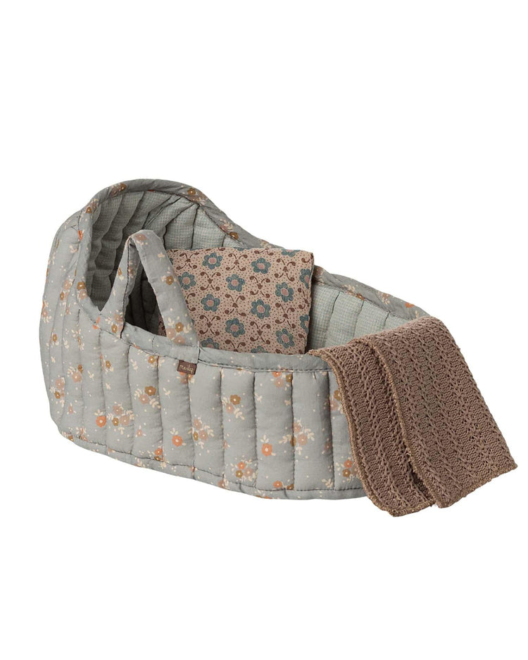 The maileg large carry cot in blue features handles, a cozy interior, and a patterned design—perfect as a plush toy accessory or portable bed.