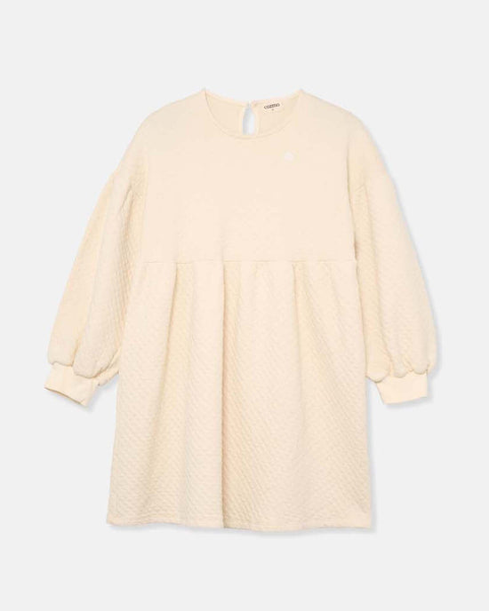 The creta diamond quilted dress in ivory by cozmo features long sleeves, a round neckline, gathered waist, and single back button closure—crafted from cozy fabrics as part of the Back to Cozmo collection.