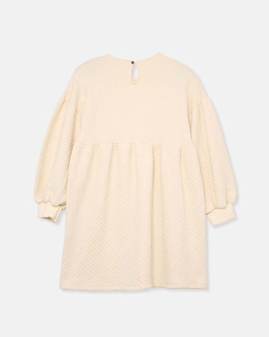 The creta diamond quilted dress in ivory by cozmo features long sleeves, a loose fit, gathered waist, and back button closure—a cozy choice from the Back to Cozmo collection for transitional wear.