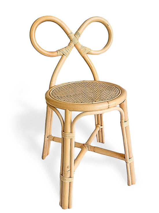 The Poppie Bow Chair by poppie toys features a circular woven seat and an ornate, looped backrest evocative of a bow or infinity symbol—ideal as a kids chair or vanity chair—shown here against a white background.