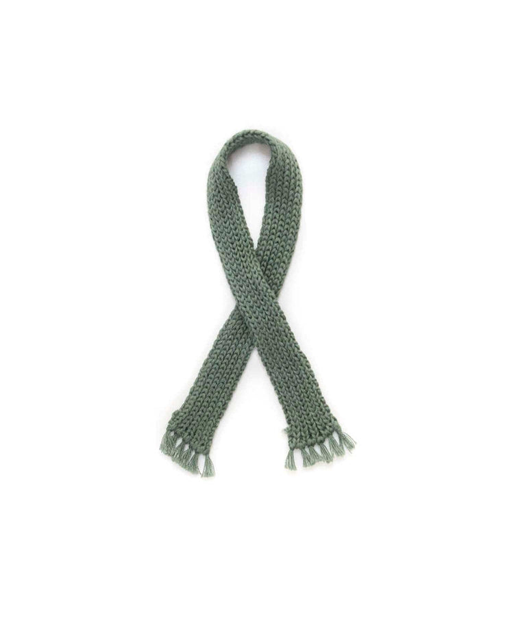 A cozy bear-striped sweater with a green scarf by tun tun, arranged in a crisscross pattern on a white background, evoking the charm of handmade heirloom-quality toys.