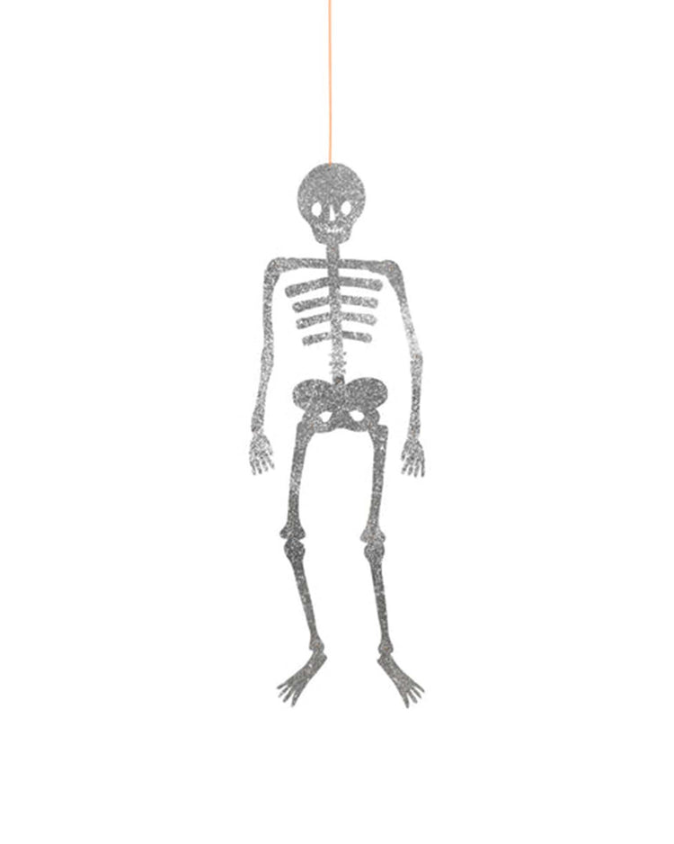 A glitter jointed skeleton decoration by meri meri hangs from an orange string against a white background, adding a festive touch to your Halloween skeleton decorations collection.