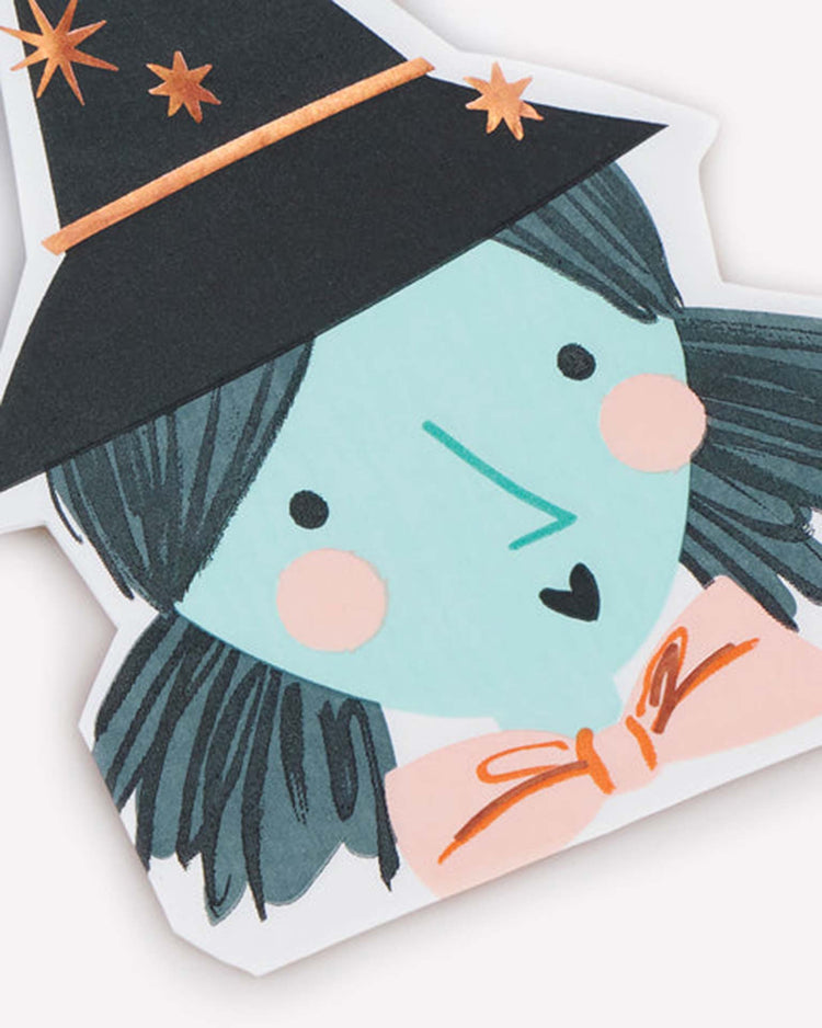 Add a touch of whimsy to your party table setting with the meri meri witch shaped napkins, featuring a cartoon witch with blue skin, black hair, rosy cheeks, a black hat adorned with stars, and an orange bowtie—an enchanting Halloween design perfect for your celebration.