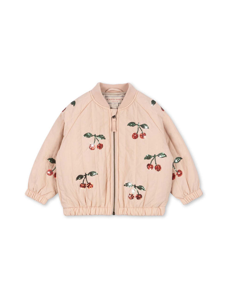 The juno sequin bomber jacket in cameo rose by konges sløjd is a light pink children's bomber jacket featuring a front zipper and elastic cuffs, adorned with an embroidered cherry pattern throughout. This lightweight outerwear is displayed laid flat on a plain white background.