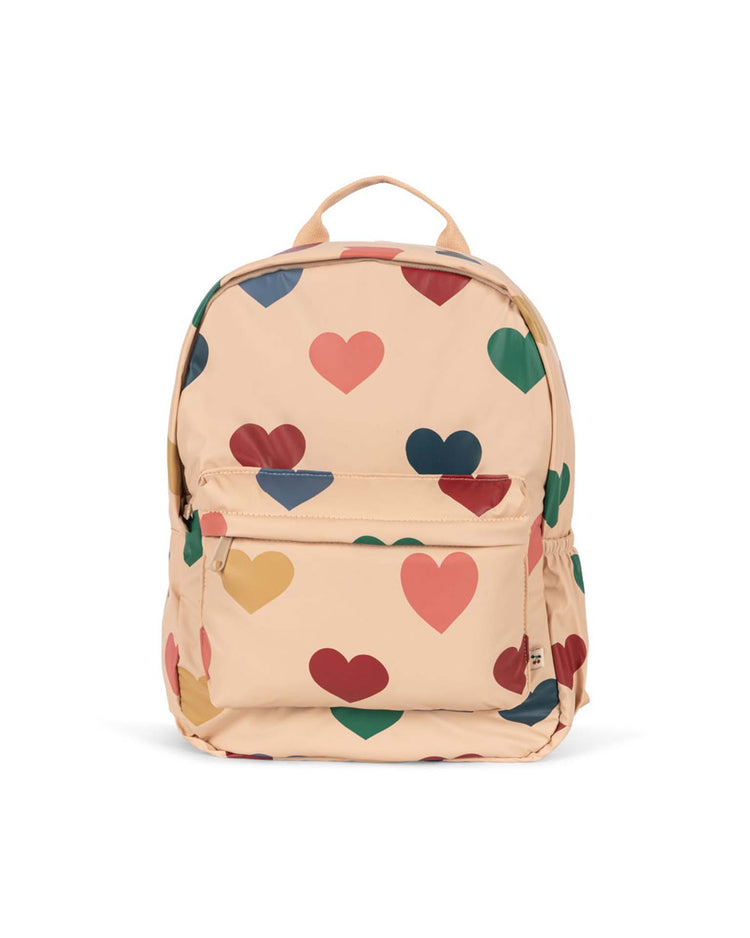 Introducing the rainy backpack in bon coeur coloré by konges sløjd—a beige, lightweight kids adventure backpack adorned with a playful pattern of large, multicolored hearts in red, pink, green, blue, and yellow. It features a convenient front zipper pocket and a top handle for easy carrying.
