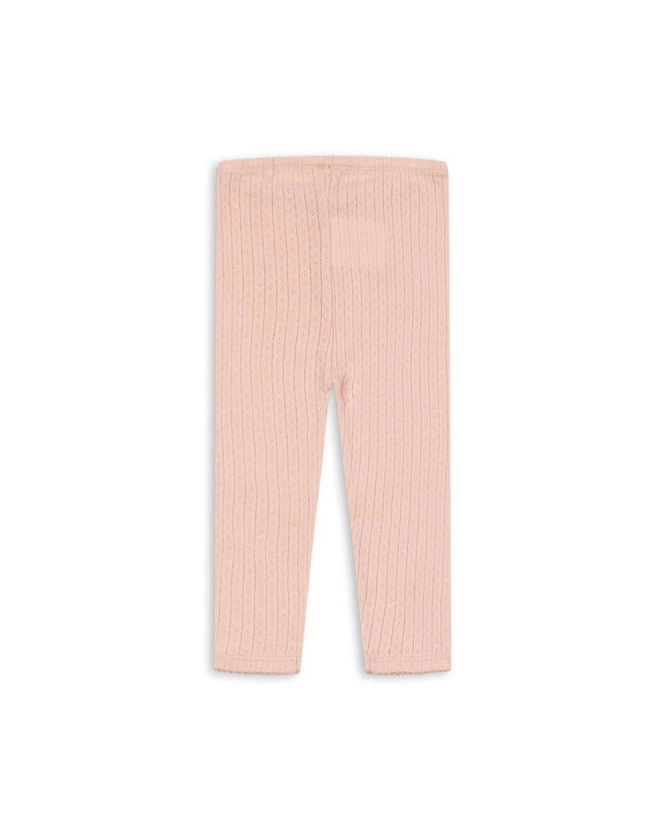 The "minnie pants in pale blush" by konges sløjd are light pink, ribbed knit organic cotton leggings for babies, shown flat on a white background. These soft basics feature an elastic waistband and are free from visible patterns or decorations.