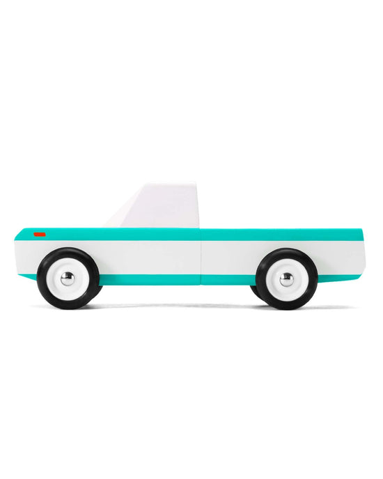Simplified graphic of a candylab longhorn teal pickup with surfboards in the truck bed, showcasing a minimalistic design on a white background.