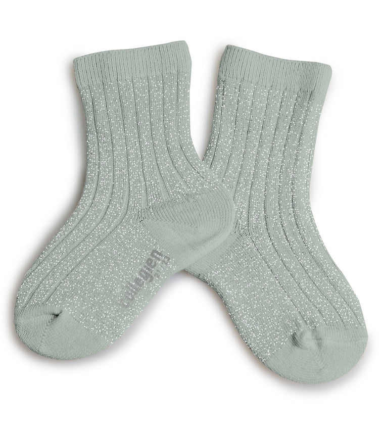A pair of pale green Collegien Victoire crew socks in aigue marine with ribbed texture and glittery detailing isolated on a white background.