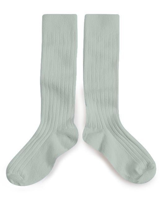 A pair of le haute socks in aigue marine by Collegien on a white background.