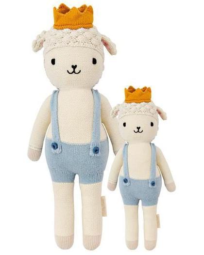 Two Sebastian the Lamb plush toys from cuddle + kind, named Sebastian and Little Prince, wearing crowns and overalls against a white background, symbolizing the charity goal of providing 1 million meals.