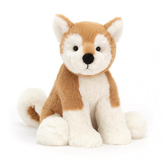 A brown and white Jellycat Milo Shiba Inu stuffed animal sitting on a white background.
