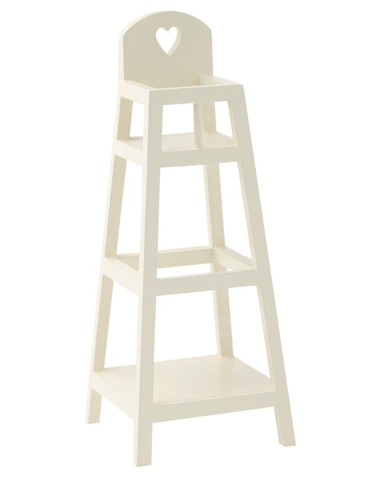 A Maileg my high chair in white with a heart-shaped feeding shelf.