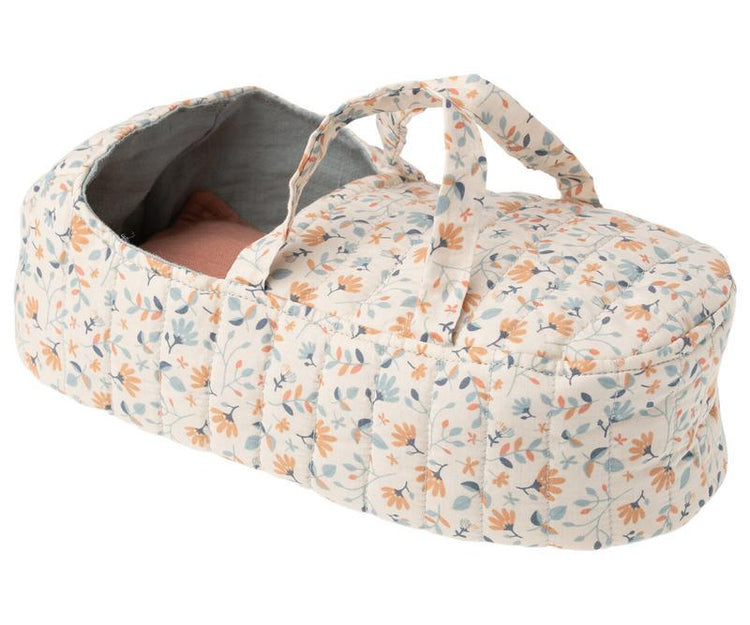A baby's Maileg quilt carry cot in blue, crafted from soft fabrics of cotton and linen.