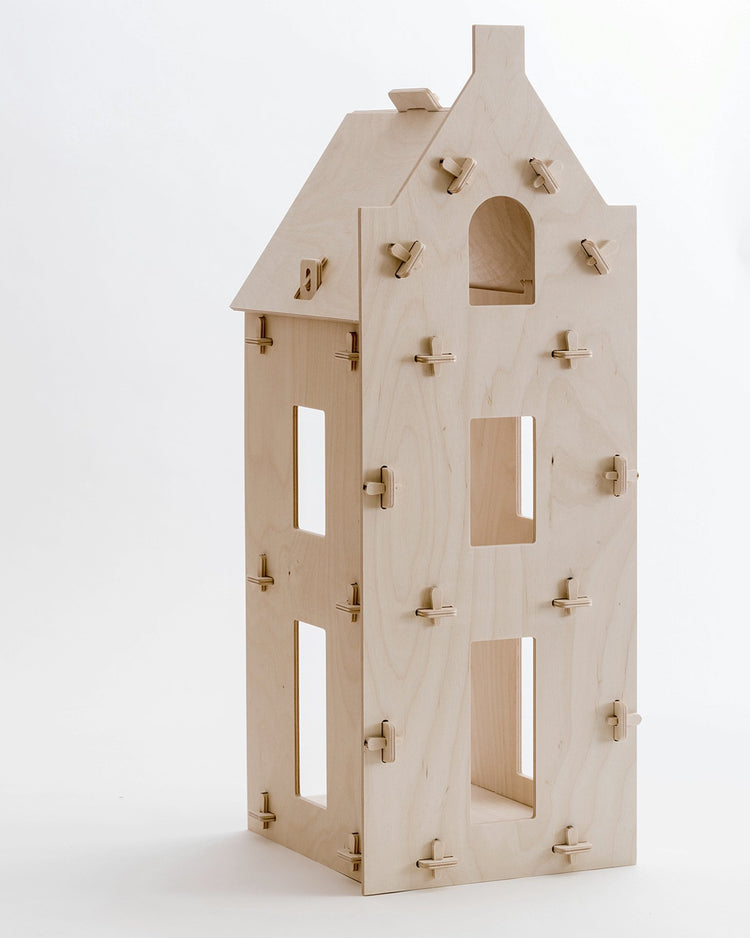 Wooden birdhouse designed to resemble a stepped gable dollhouse from Maquette Kids with multiple entrances and perches.
