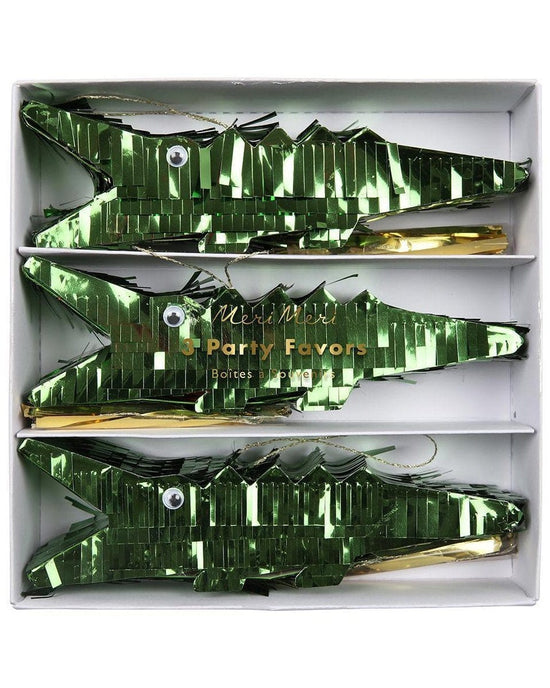 A box containing green crocodile piñata favor noisemakers for a kid's party by meri meri.
