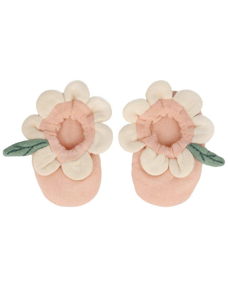 A pair of peach daisy baby booties made from organic cotton by meri meri.