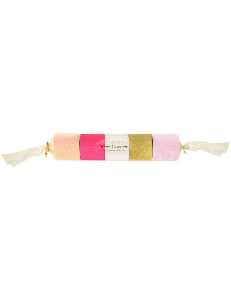 A wrapped candy with pink and gold segments, reminiscent of Meri Meri's pink crepe party streamers, isolated on a white background.