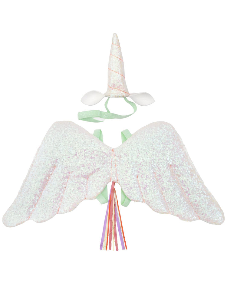 A meri meri winged unicorn dress-up set including wings, a horn headband, and a tail with ribbons on a white background.