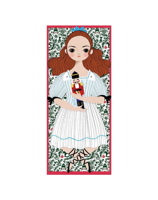 Illustration of a young girl holding a Clara Mailable Paper Doll by Of Unusual Kind, hand assembled against a floral background within a red border.