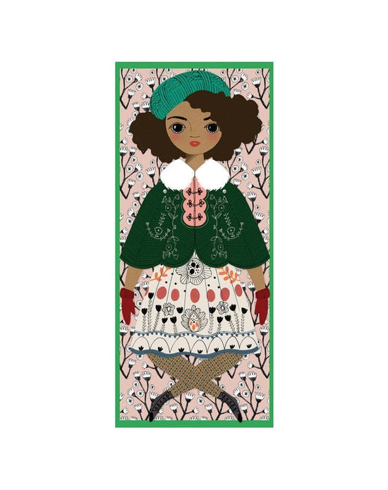 Illustration of a handmade Of Unusual Kind Noelle Mailable Paper Doll with a green hat and a patterned dress against a floral background.