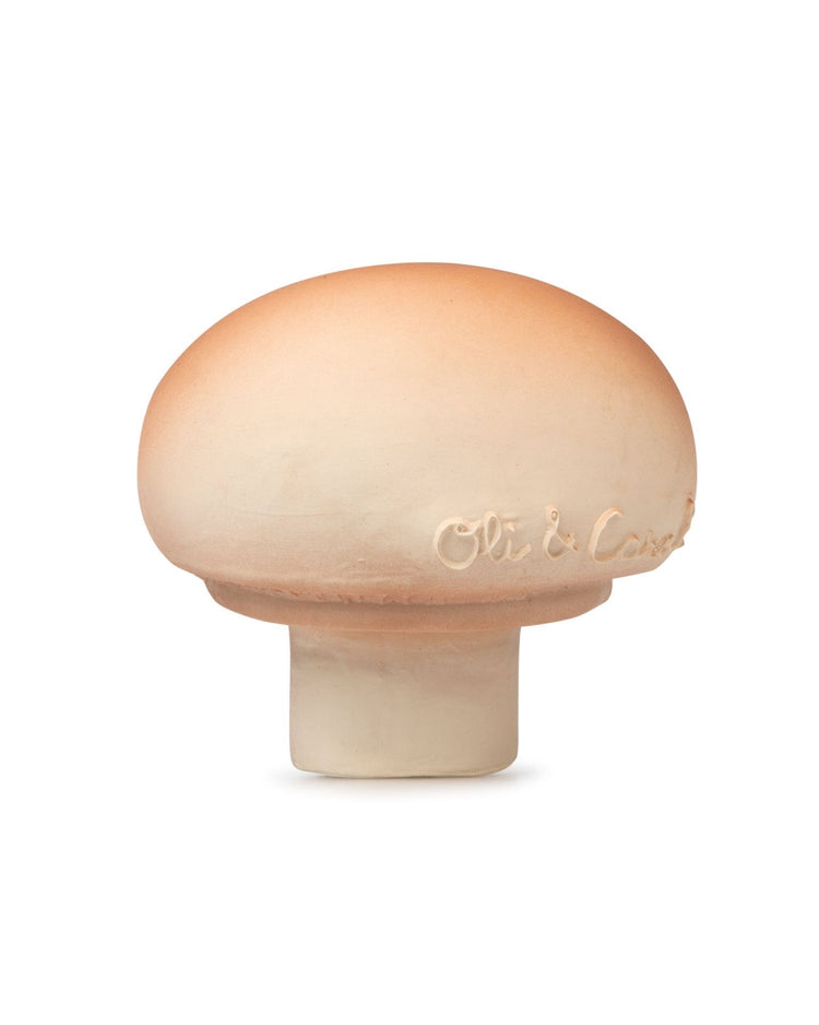 Ceramic Manolo the Mushroom baby toy by Oli + Carol with embossed text on the side.