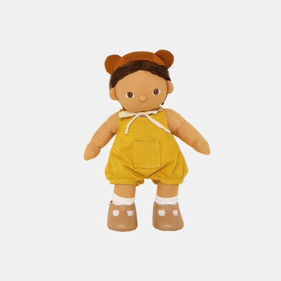 A stuffed toy with a yellow Olli Ella Dinkum Doll Mio Romper Set and brown shoes.