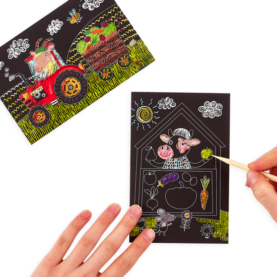 A hand holding a OOLY mini scratch & scribble art kit: farm animals - 7 piece set with a picture of farm animals and a tractor.
