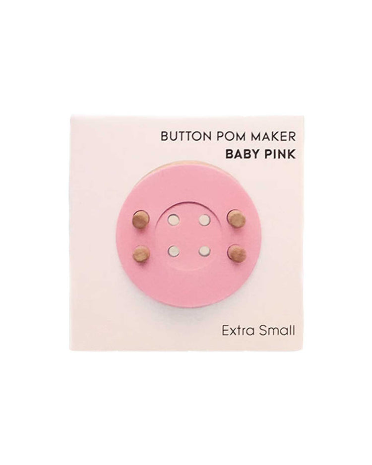 Extra small baby pink eco-friendly pom maker by pom maker on a white background.