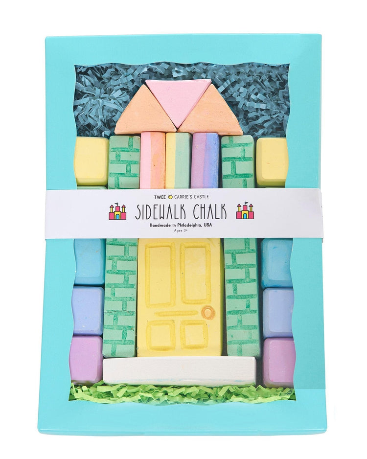 A package of Carrie's Castle sidewalk chalk shaped like castle building elements, including a door and windows, designed for creative outdoor play by Twee.